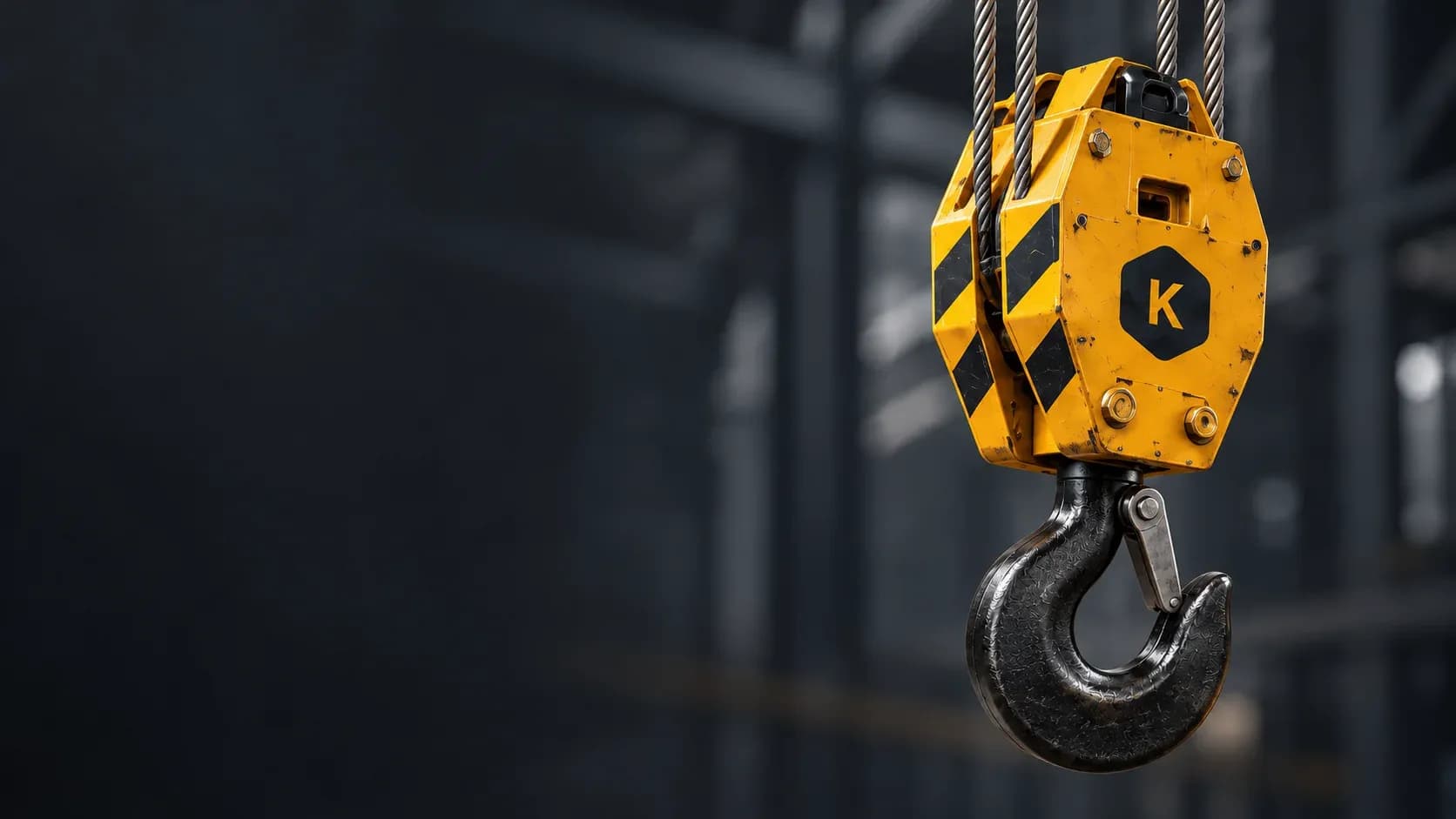 Industrial brand illustration of a bolted amber hook block with warning stripes and Krandura K emblem